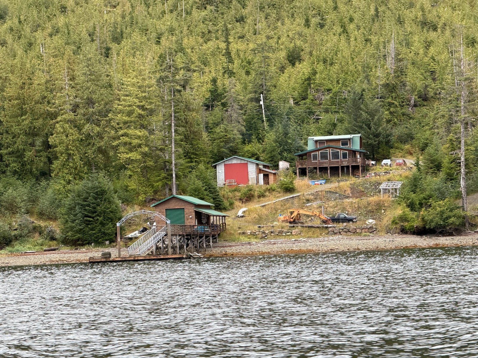 Current waterfront property with forest, buildings, and dock on Prince of Wales Island